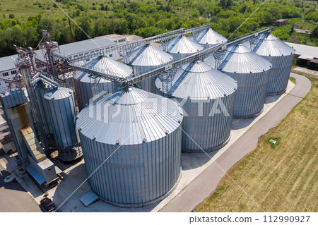 Aerial view of agricultural silos, grain elevator for storage and drying of cereals. 112990927