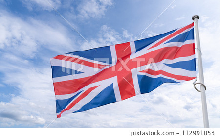 British flag flutters in the wind. State symbol of United Kingdom British flag flutters in the wind. State symbol of United Kingdom 112991053