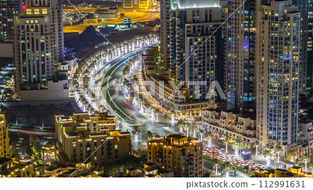 Top view of road in Dubai downtown timelapse with night traffic and illuminated skyscrapers. Top view of road in Dubai downtown timelapse with night traffic and illuminated skyscrapers. 112991631