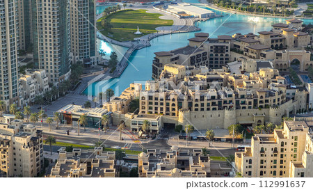 Top view of the bridge over man-made lake timelapse in Dubai downtown, United Arab Emirates. 112991637