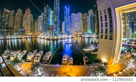 Dubai Marina towers and yachts in canal in Dubai night timelapse Dubai Marina towers and yachts in canal in Dubai night timelapse 112991683