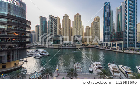 Dubai Marina towers and canal in Dubai day to night timelapse Dubai Marina towers and canal in Dubai day to night timelapse 112991690