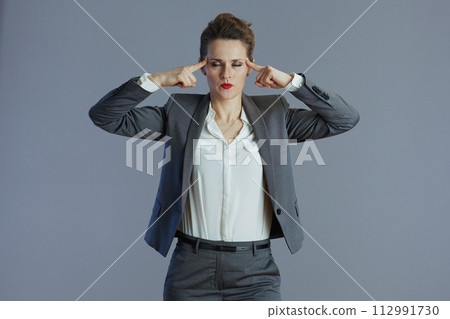 stressed elegant female employee isolated on gray background stressed elegant female employee isolated on gray background 112991730