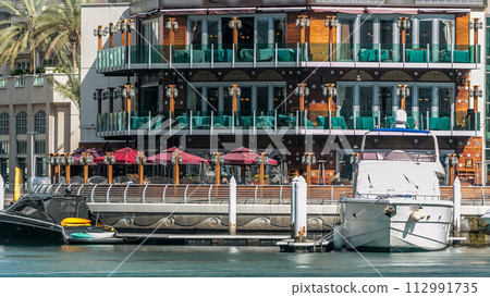 Promenade and restaurants timelapse at the marina walk, During day time. Dubai, UAE Promenade and restaurants timelapse at the marina walk, During day time. Dubai, UAE 112991735