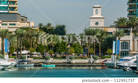Fountain and palms timelapse at the marina walk, During day time. Dubai, UAE Fountain and palms timelapse at the marina walk, During day time. Dubai, UAE 112991737