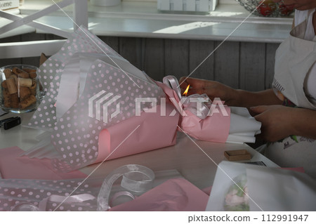 Woman businesswoman makes marshmallow bouquet. Marshmallow flowers. Marshmallow tulips. Homemade marshmallows. 112991947