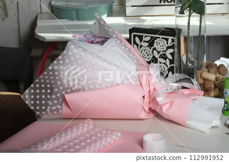 wedding bouquets in kraft paper and tied with ribbon. 112991952