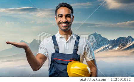 Portrait on mature happy handyman presenting something 112991982