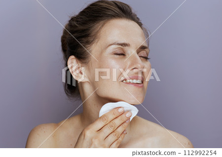 smiling modern woman with cotton pad smiling modern woman with cotton pad 112992254
