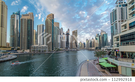 Dubai Marina towers and canal in Dubai day to night timelapse 112992918