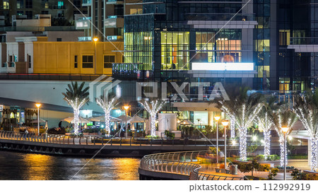 Promenade in Dubai Marina timelapse at night, UAE. Promenade in Dubai Marina timelapse at night, UAE. 112992919