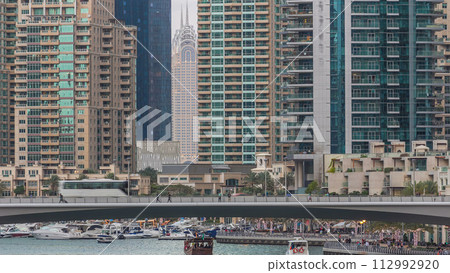 Dubai Marina towers and canal in Dubai day to night timelapse Dubai Marina towers and canal in Dubai day to night timelapse 112992920