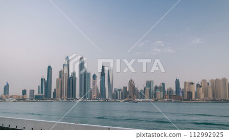 Dubai Marina skyline day to night timelapse as seen from Palm Jumeirah in Dubai, UAE. 112992925
