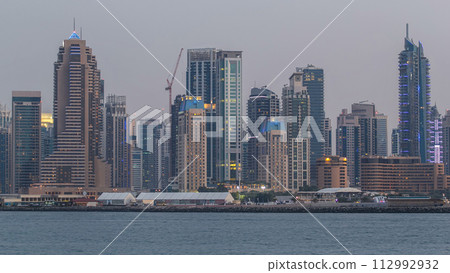Dubai Marina skyline day to night timelapse as seen from Palm Jumeirah in Dubai, UAE. 112992932