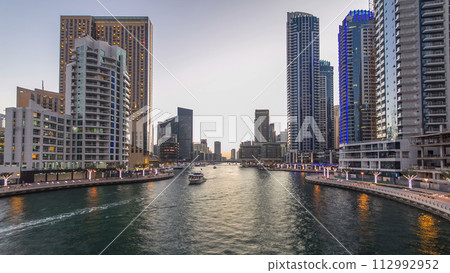 Dubai Marina towers and canal in Dubai day to night timelapse 112992952