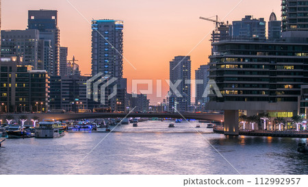 Dubai Marina towers and canal in Dubai day to night timelapse 112992957