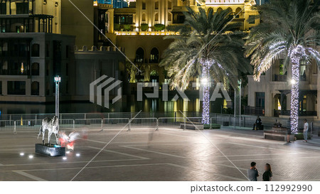 Square with horse monument near Souk in downtown timelapse in Dubai, UAE Square with horse monument near Souk in downtown timelapse in Dubai, UAE 112992990