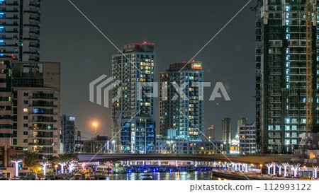 Promenade in Dubai Marina timelapse at night, UAE. 112993122