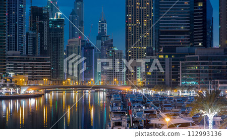 Dubai Marina towers and canal in Dubai night to day timelapse 112993136