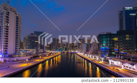 Dubai Marina towers and canal in Dubai night to day timelapse 112993138