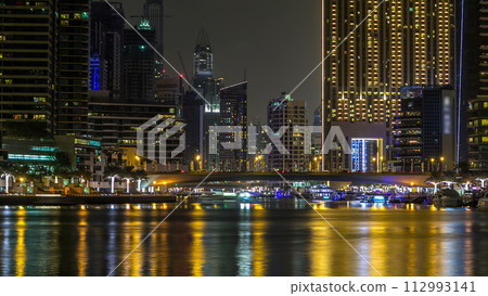 Promenade in Dubai Marina timelapse at night, UAE. 112993141