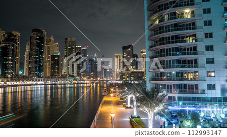 Promenade in Dubai Marina timelapse hyperlapse at night, UAE. 112993147
