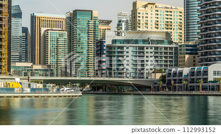Towers and bridge in Dubai Marina timelapse, UAE. Towers and bridge in Dubai Marina timelapse, UAE. 112993152