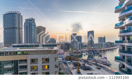 An Aerial view of Dubai Marina towers in Dubai day to night timelapse An Aerial view of Dubai Marina towers in Dubai day to night timelapse 112993160