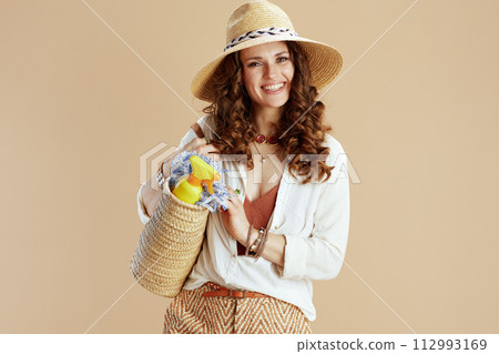 smiling elegant woman in blouse and shorts on beige smiling elegant woman in blouse and shorts on beige 112993169
