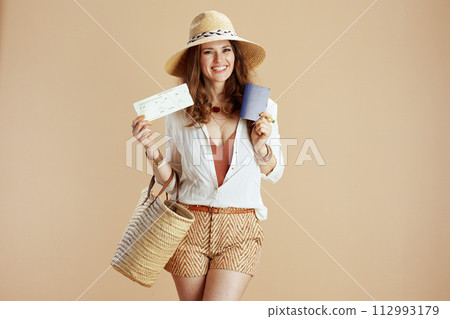 happy woman in blouse and shorts on beige happy woman in blouse and shorts on beige 112993179
