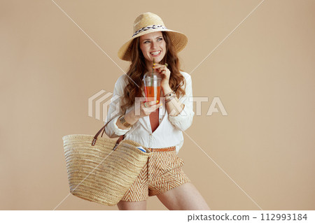 happy woman in blouse and shorts against beige happy woman in blouse and shorts against beige 112993184