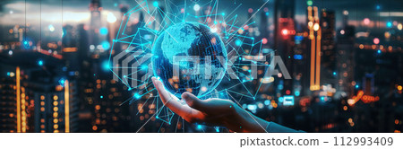 A futuristic globe-shaped holographic graphic is displayed on the left hand and blurs the atmosphere during the early hours of a future city. banner picture. A futuristic globe-shaped holographic graphic is displayed on the left hand and blurs the atmosphere during the early hours of a future city. banner picture. 112993409