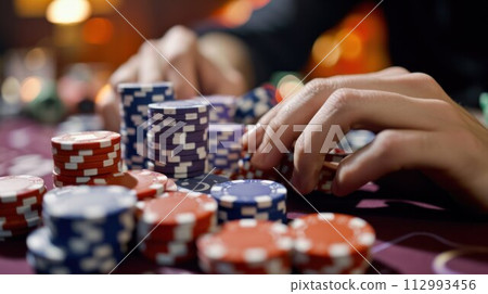 casino, gambling, poker, people and entertainment concept - close up of poker player with chips casino, gambling, poker, people and entertainment concept - close up of poker player with chips 112993456