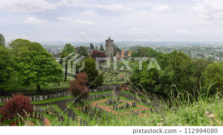 Sweeping panorama of serene Church of the Holy Rude Cemetery in Stirling, nestled among lush foliage Sweeping panorama of serene Church of the Holy Rude Cemetery in Stirling, nestled among lush foliage 112994080