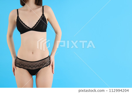 Slim girl in underwear, on a light background. Slim girl in underwear, on a light background. 112994204