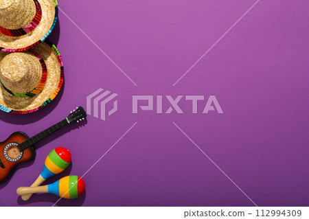 Mexican sombrero with decorative guitar and maracas 112994309