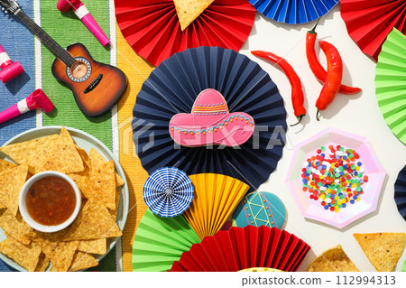 Nachos in a bowl with sauce and festive decorations 112994313