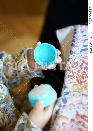 child's hands playing with small objects 112994334