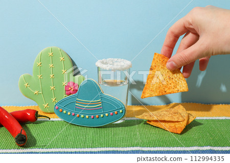 A shot of tequila with nachos and decorations 112994335