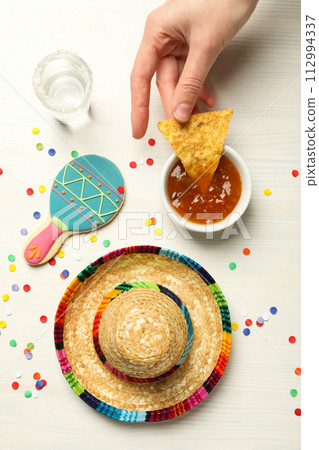 Nachos with sombrero and tequila on a light background 112994337