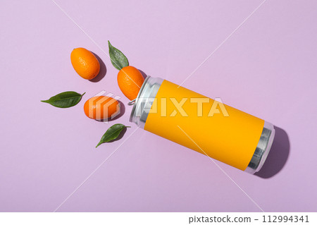 Tin can and kumquats on purple background, top view 112994341