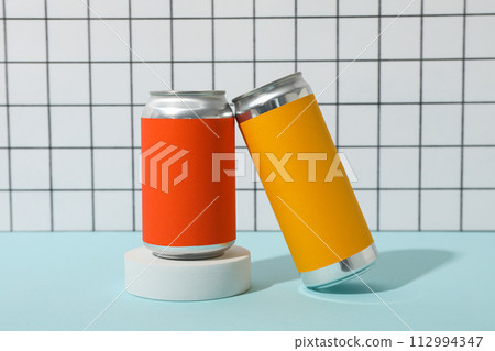 Tin cans on blue table on light background Tin cans on blue table on light background 112994347