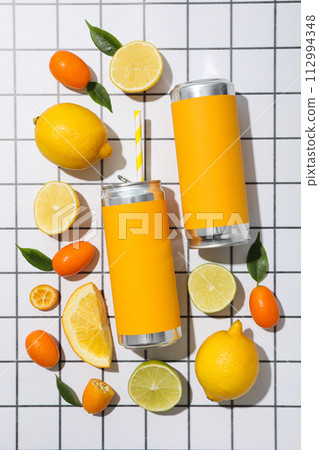 Tin can and citrus fruits on light background, top view Tin can and citrus fruits on light background, top view 112994348