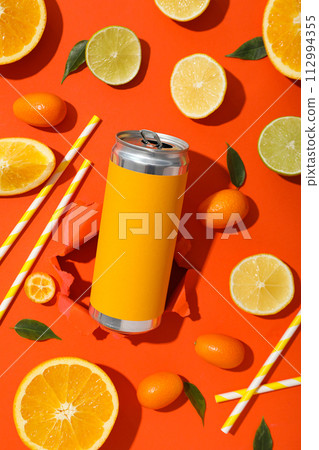 Tin can, straw and citruses on orange background, top view Tin can, straw and citruses on orange background, top view 112994355