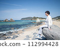 Men relaxing on the coast 112994428