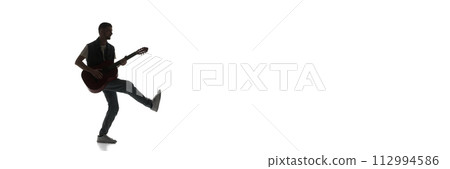 Silhouette of man cheerfully playing guitar isolated on white background. Black and white image. Silhouette of man cheerfully playing guitar isolated on white background. Black and white image. 112994586