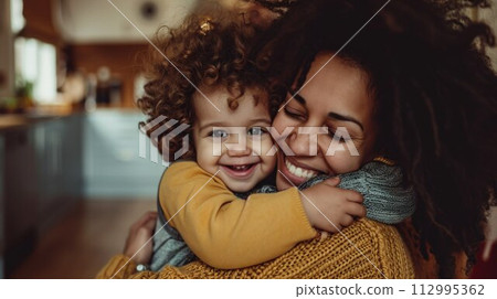 Affectionate loving middle aged mother cuddling child. Excited to see daughter, happy senior older mom cuddling her, sitting together on comfortable sofa in living room 112995362