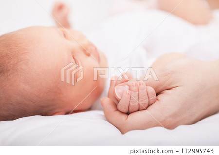 Newborn Baby Asleep Holding Mother Newborn Baby Asleep Holding Mother 112995743