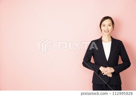 Smiling business woman with pink background 112995826