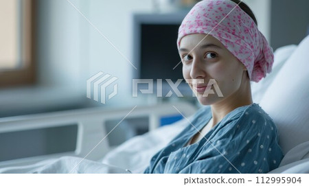 Young cancer woman lying in hospital bed 112995904